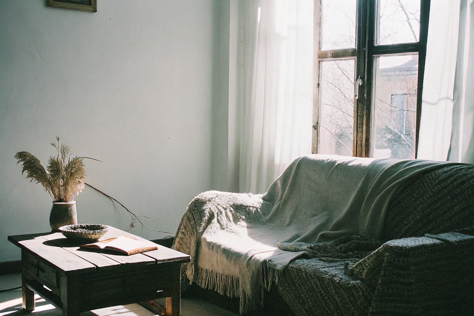Cozy wabi-sabi living room with linen throw, dried botanicals, and soft natural light